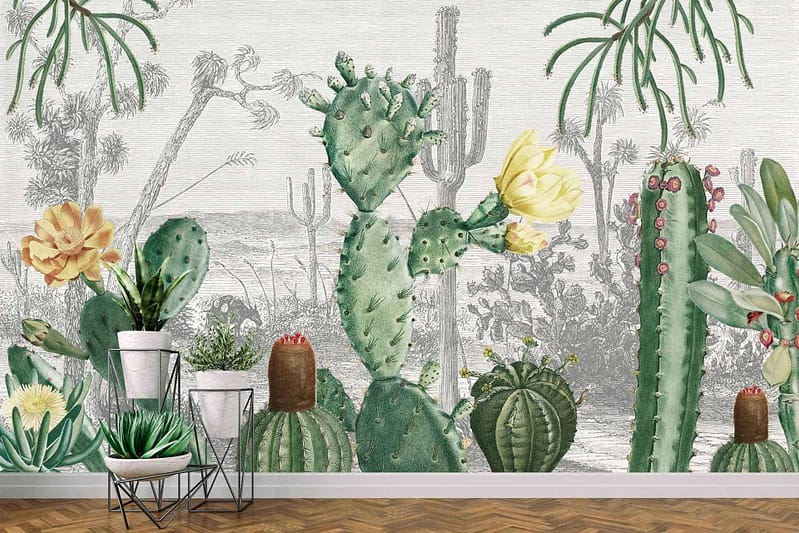 The wallpaper in Cactus Heaven features watercolor illustrations of various cacti species set against a desert landscape. It includes shades of green, brown, and beige with touches of yellow and pink accents found in cactus flowers. The elements include saguaro, prickly pear, and barrel cactus, along with desert flora like agave and yucca.