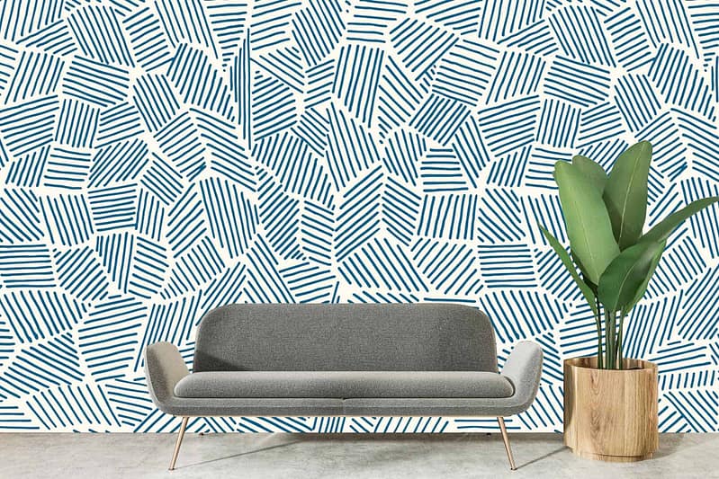 Abstract blue geometric pattern on white wall.
