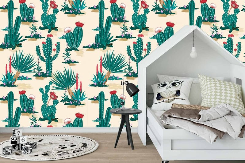 The wallpaper features a vibrant cactus and succulent pattern. It includes various shades of green, with splashes of pink, yellow, and brown detailing the desert plants. The design adds a cowboy flair to the decor.