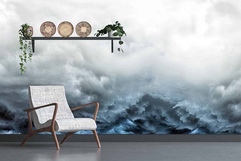 The wallpaper features tumultuous, stormy waves in deep blues and grays beneath white cumulus clouds.