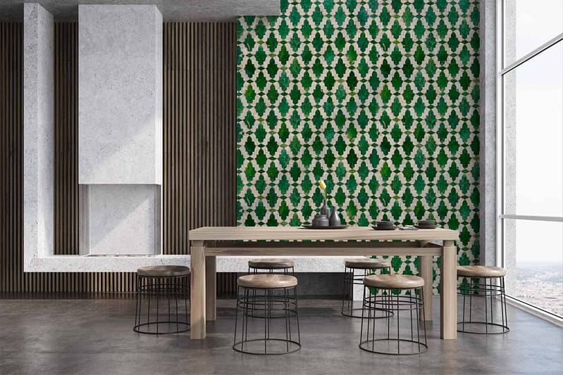The dining room features a striking green and white geometric patterned wallpaper. The design showcases intricate shapes and lines, delivering a bold contrast with the vertical wooden slats nearby. The green hues range from deep forest tones to lighter shades, while the crisp white provides a clean backdrop, enhancing the dynamic pattern. This wallpaper evokes a modern aesthetic with a touch of Cypriot influence in its geometry.