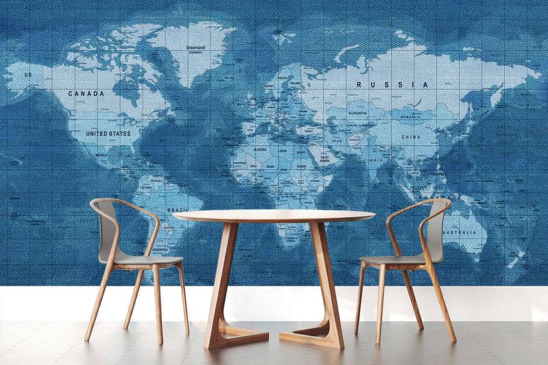 The wallpaper showcases a large world map in shades of blue, featuring clearly marked country names and borders. The design adds a touch of global fashion reminiscent of classic denim styles, with varying hues and tones that create depth and interest.