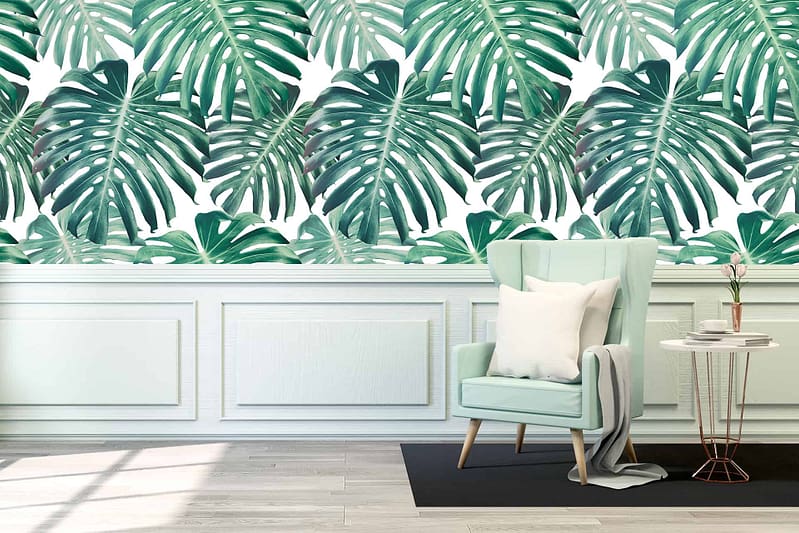 Vibrant tropical leaf pattern, featuring bold green leaves with hints of blue and yellow on a white background.
