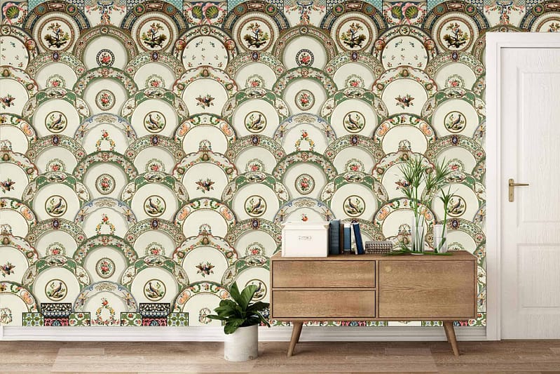 Ornate, decorative wallpaper featuring a repeating pattern of plates with intricate floral and bird designs. Elements include flowers and birds. Colors: various shades of blue, green, red, and yellow on a white or light background.