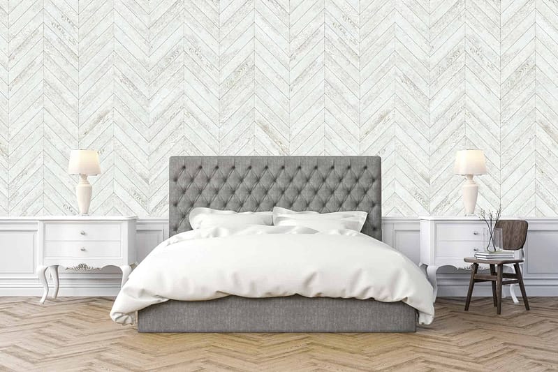 The wallpaper features a light chevron pattern, incorporating soft, neutral tones such as beige, cream, and light grey. The subtle interplay of colors provides an elegant and serene backdrop for the room.