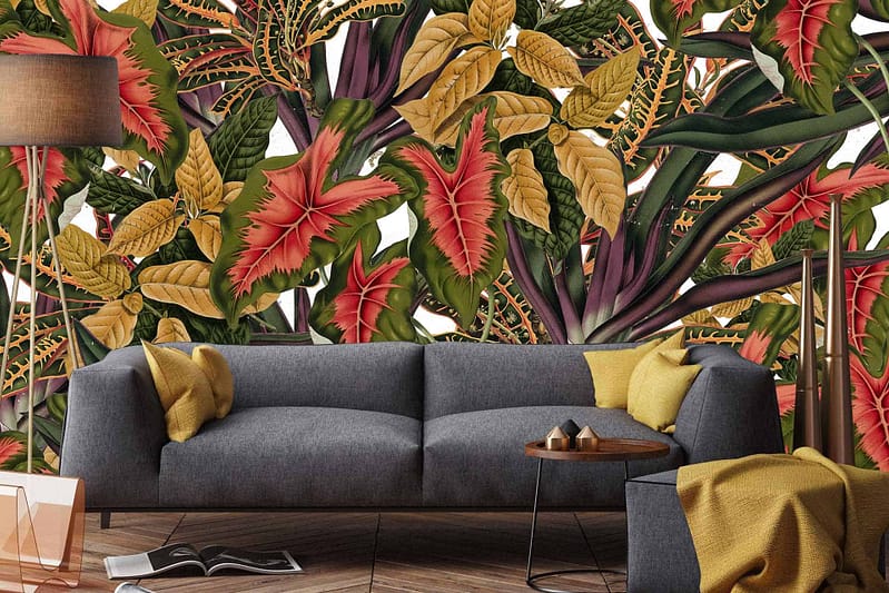 The wallpaper features vibrant tropical leaves in various shades of green, with accents of deep blues and bright yellows. The lush patterns include intricate details of monstera, palm fronds, and other foliage designs. Perfect for plant enthusiasts seeking an exotic, nature-inspired aesthetic.