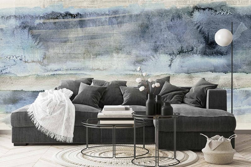 Abstract, blue and white art on wall; swirling patterns of oceanic blues, sky tones blending into stark whites; hints of dark navy streaks interspersed with soft azure waves.