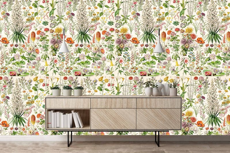The wallpaper features vibrant floral patterns with blooming roses, daisies, and peonies in shades of pink, red, yellow, and white. Lush green leaves intertwine throughout the design. The pattern is rich with botanical elements from Elizabeth's Garden collection.