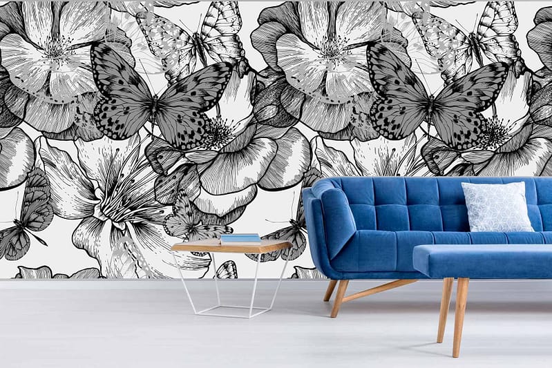 The wallpaper in the modern living room features large, intricate black and white floral designs, complemented by elegant butterfly motifs. The butterflies symbolize the grace of their first flight, creating an eye-catching and artistic backdrop. This monochromatic palette brings sophistication and contrast to the room.