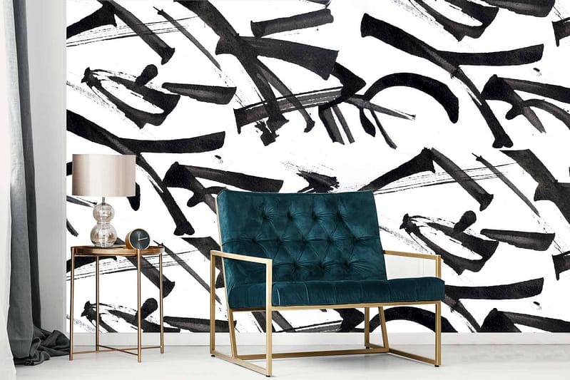 The wallpaper features free hand abstract black brush strokes on a white surface. This contemporary design offers an artistic vibe with its bold, contrasting elements and minimalistic color palette. Ideal for modern living spaces seeking a unique and stylish backdrop.