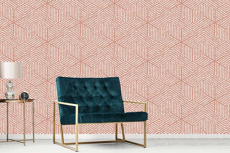 The wallpaper features a geometric pattern in shades of pink and white, adding a modern and vibrant touch to the room. The mix of these colors creates an eye-catching backdrop that enhances the overall aesthetic.