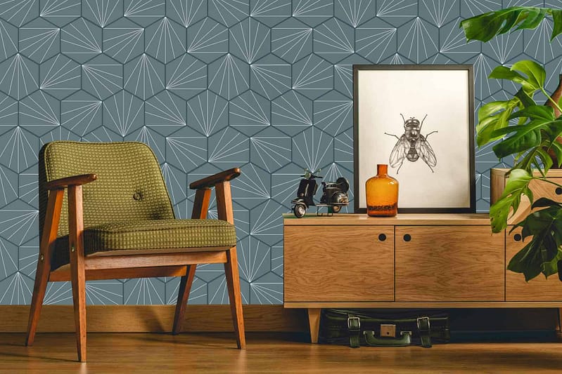 The wallpaper features a retro geometric pattern with overlapping shapes in muted shades of green, mustard yellow, burnt orange, and cream. The design exudes mid-century modern flair through its stylish repetition and harmonious color palette.
