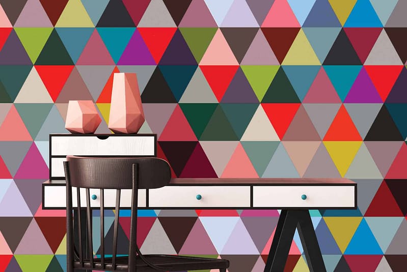 The wallpaper features a colorful, vibrant pattern of multicolored triangles, some forming isosceles shapes. It combines various hues in a geometric design, reminiscent of geometry class.