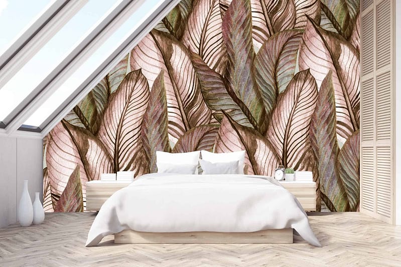 The wallpaper showcases a tropical leaf mural in earthy tones. It features various shades of green, brown, and beige, adding a natural and calming aesthetic to the slanted wall in the modern bedroom.