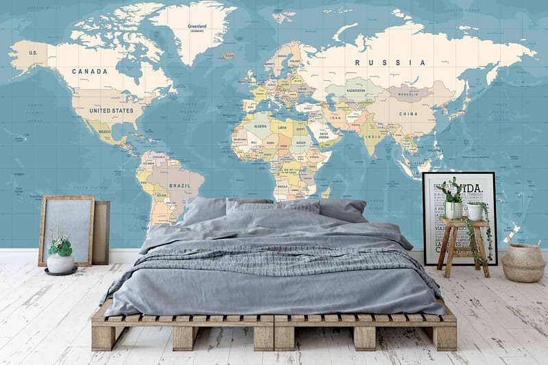 A large world map mural covers the entire wall, featuring earthy tones of brown, tan, and green for landmasses. Deep blue and teal hues represent the oceans. Detailed with white lines indicating latitude and longitude, and black labels for countries and cities.