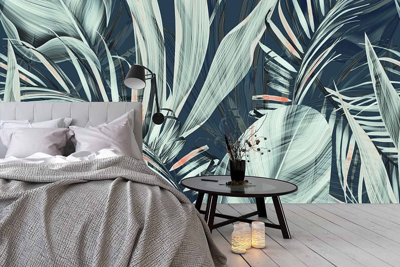 The wallpaper features a large tropical leaf mural, with lush green foliage creating a jungle vibe. The leaves are in various shades of green, giving depth and realism to the design.