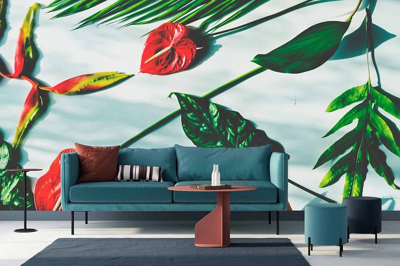 The wallpaper showcases a large, vibrant mural of tropical leaves and flowers. It features elements like palm fronds, monstera leaves, hibiscus blossoms, and bird of paradise plants. The colors include rich greens, bright pinks, deep blues, and sunny yellows.