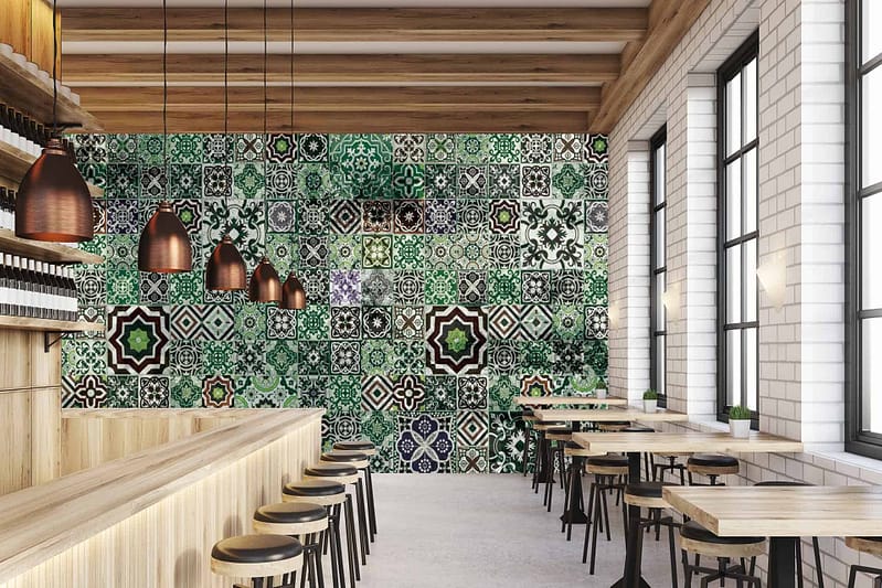 Vibrant wall with geometric tiles in green, black, and white, reminiscent of Marrakech.