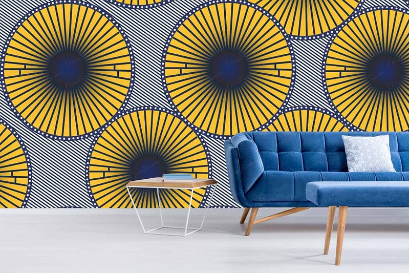 The wallpaper features a vibrant geometric sunburst pattern in yellow, blue, and black from Nelson's Threads collection.