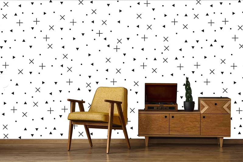 The wallpaper features a white background with a black scatter pattern, including elements reminiscent of Noughts and Crosses. The pattern consists of plus signs, triangles, and dots in an irregular arrangement. This bold but simple monochrome design makes the elements—plus signs, triangles, dots—stand out against the white backdrop.