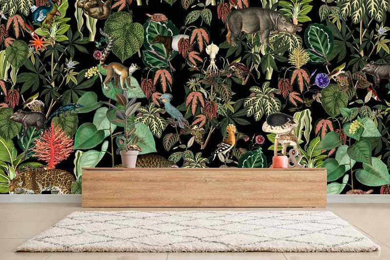 A room with dark background wallpaper featuring various animals and plants. The vivid pattern showcases colorful birds, butterflies, flowers, leaves, and tree branches. Splashes of green, red, orange, yellow, and blue dominate the intricate designs against the dark backdrop.