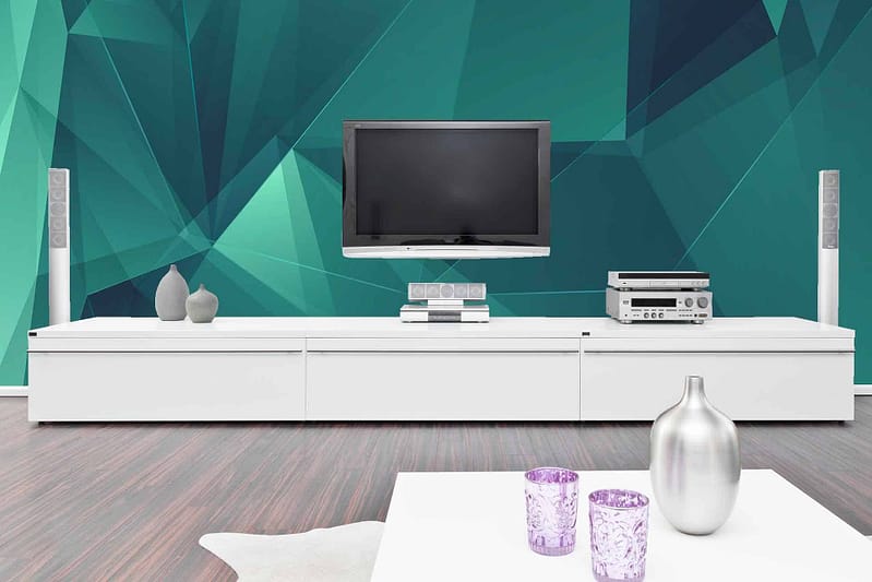The geometric teal accent wall features interlocking patterns in shades varying from deep teal to light turquoise. The design incorporates sharp angles and clean lines, creating a modern, dynamic look that contrasts with the room’s other elements.