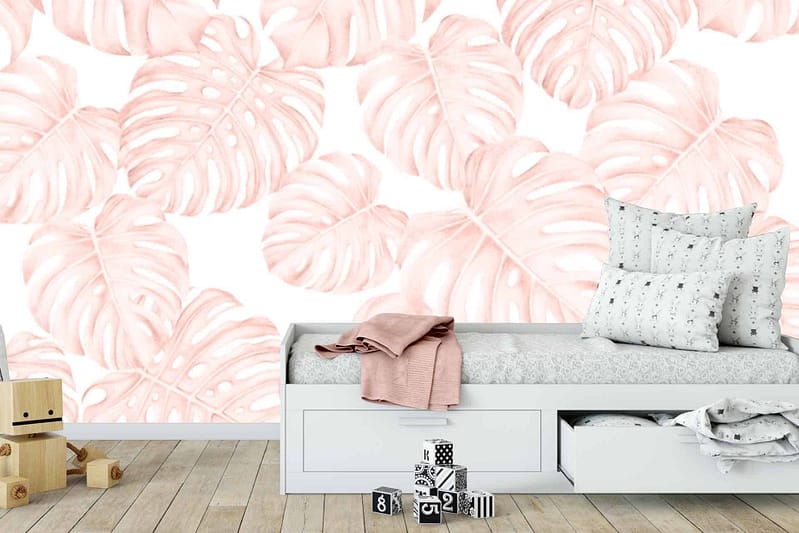 A soft pink monstera leaf pattern adorns the wall. The wallpaper features leafy elements in varying shades of pink.