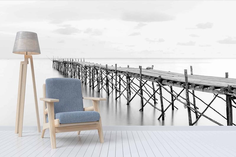 The wallpaper features a large black-and-white mural depicting a tranquil scene from "Prince of Tides," showcasing an old wooden pier extending into calm water.