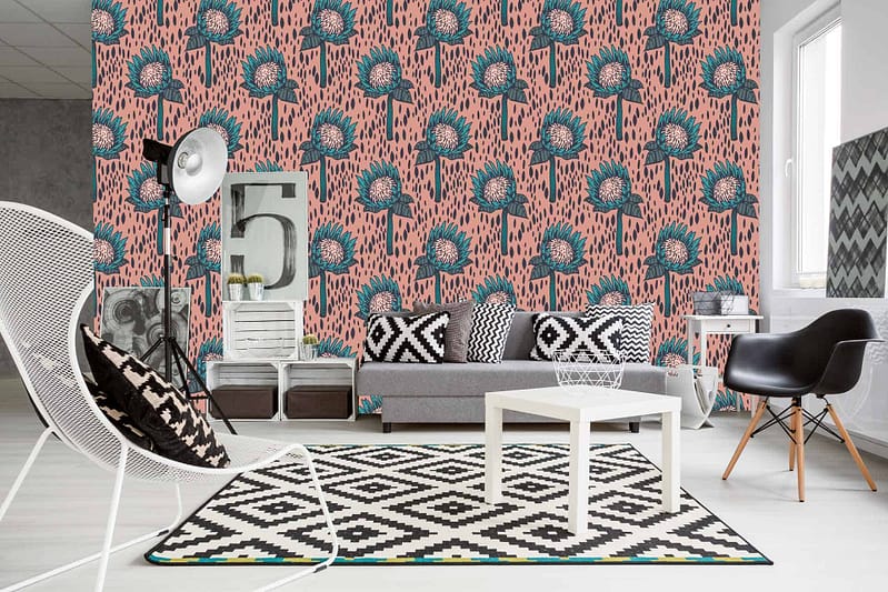 A modern living room with a standout pink and teal floral patterned accent wall. The wallpaper features vibrant pink flowers intertwined with rich teal leaves and intricate details in various shades of green and blue. This dynamic combination of colors adds a lively, yet sophisticated touch to the space.