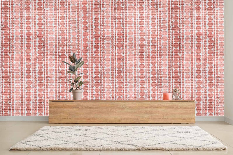 The room features a modern aesthetic with a striking red and white patterned wallpaper. The vivid red contrasts sharply against the crisp white, creating an eye-catching backdrop. Geometric and intricate designs dominate the wallpaper, adding a layer of visual complexity that enhances the minimalist decor. This bold choice of colors and patterns sets a dynamic tone for the space.