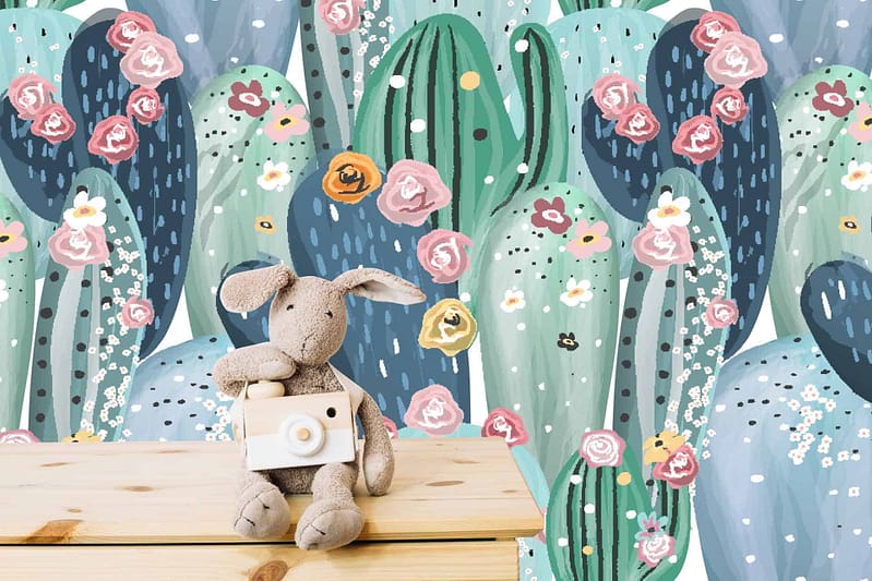 Colorful wallpaper with various cacti adorned with pink, yellow, and white flowers. Whimsical and lively contrast. Feels like cacti are dancing in the rain. Elements: Cacti, flowers (pink, yellow, white), dancing in rain pattern.