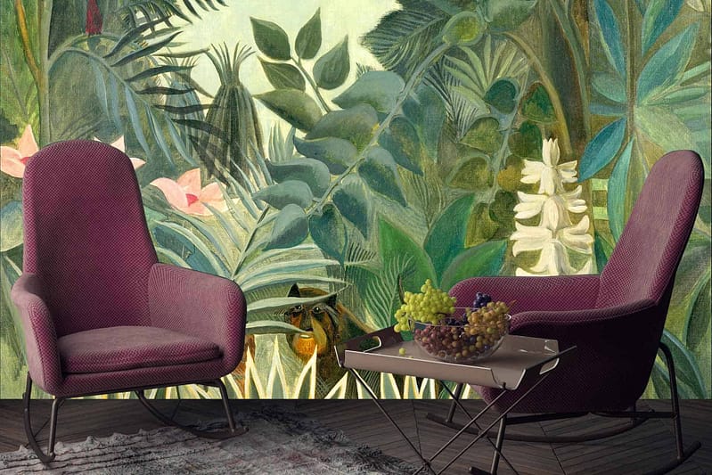 The artistic wallpaper features a depiction of Rousseau’s Jungle, showcasing lush green foliage and vibrant tropical plants. Elements include towering palms, broad leaves, exotic flowers, and hidden wildlife. The color palette is rich with various shades of green complemented by pops of bright colors like reds, yellows, and oranges from the flowers and fauna.