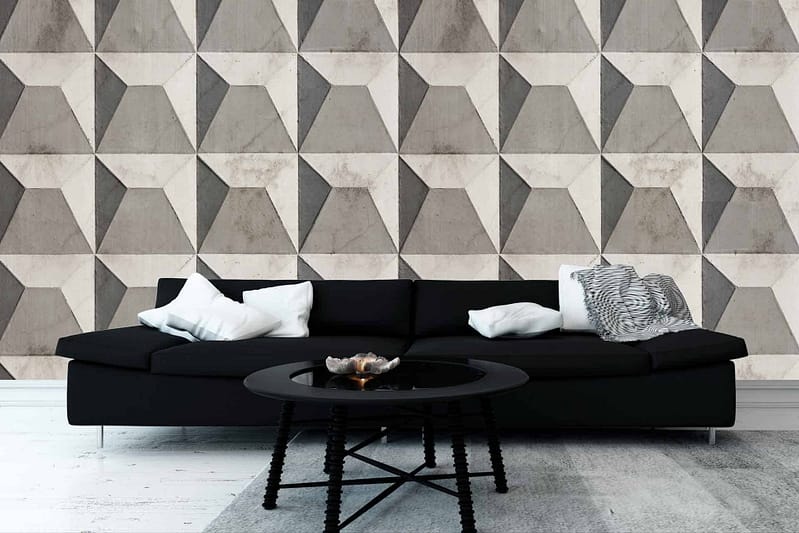 The living room showcases a geometric-patterned wallpaper in shades of gray, featuring a contemporary design with various shapes and angles. The durable finish ensures safety while echoing modern aesthetics.