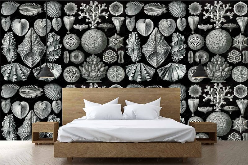 The wallpaper features a black and white color scheme with intricate shell designs, highlighting elements of coastal themes. The pattern showcases detailed depictions of various shells, creating a textured and elegant visual appeal.