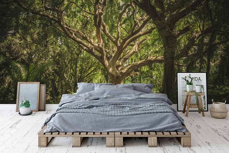 The wallpaper features a large mural of a vibrant green forest. Elements include lush trees, dense foliage, and natural scenery. Predominant colors are various shades of green with hints of brown for tree trunks and earthy tones for the forest floor.