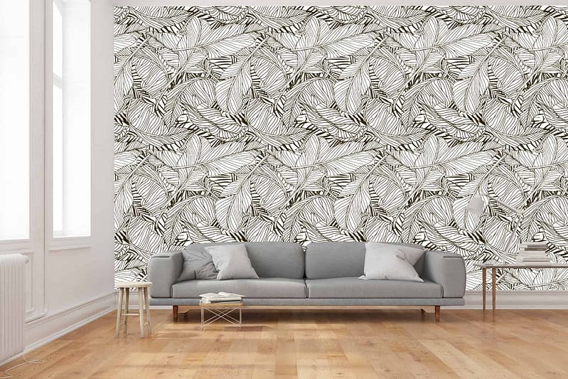 The wallpaper features a bold, black and white leaf pattern. The design consists of large, intricate black leaves set against a crisp white background. The contrast between the black and white creates a striking visual, adding depth and character to the room.