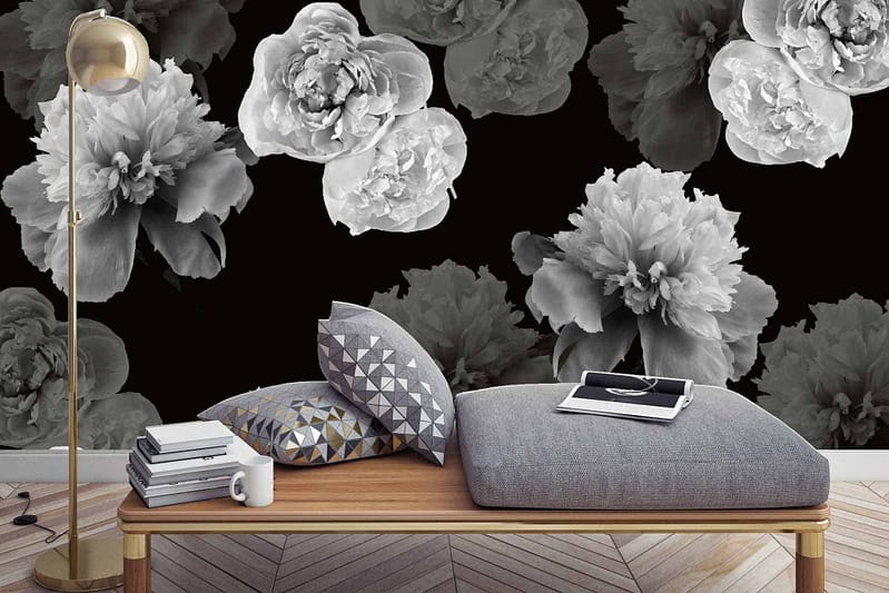 The accent wall boasts bold **black wallpaper** adorned with **oversized grayscale flower prints**, creating a dramatic backdrop. The striking combination of **black** and varying shades of **gray** in the floral design adds depth and visual impact.