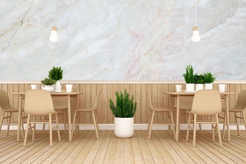 The wallpaper features a marble-like finish, characterized by swirling patterns of whites, grays, and subtle hints of warmer tones like beige. The textural element adds depth and sophistication to the space.