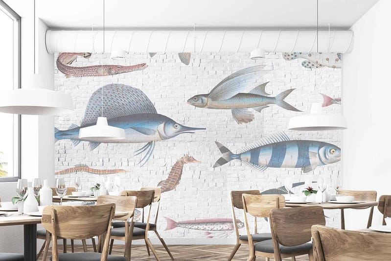 The wallpaper is a large mural featuring various fish, including a swordfish swimming upstream and flying fish. It incorporates marine themes with elements of underwater life. The colors are primarily shades of blue, white, and subtle grays to evoke oceanic scenery against the white brick backdrop.