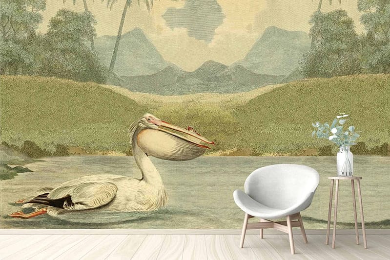 A serene nature scene wallpaper: features a tranquil pond with a pelican, surrounded by lush trees and majestic mountains. Soft blue waters, greenery, earthy browns, and muted mountain hues compose the calming palette.