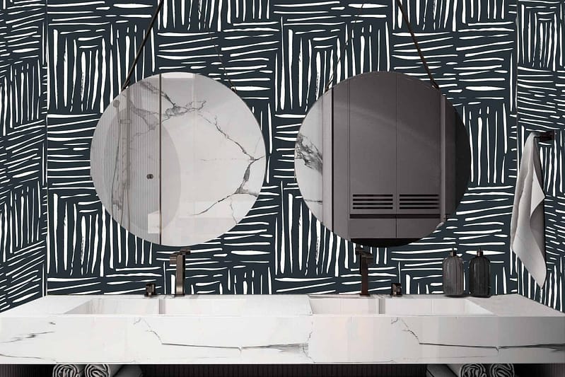 A modern bathroom features wallpaper with a black and white abstract pattern.