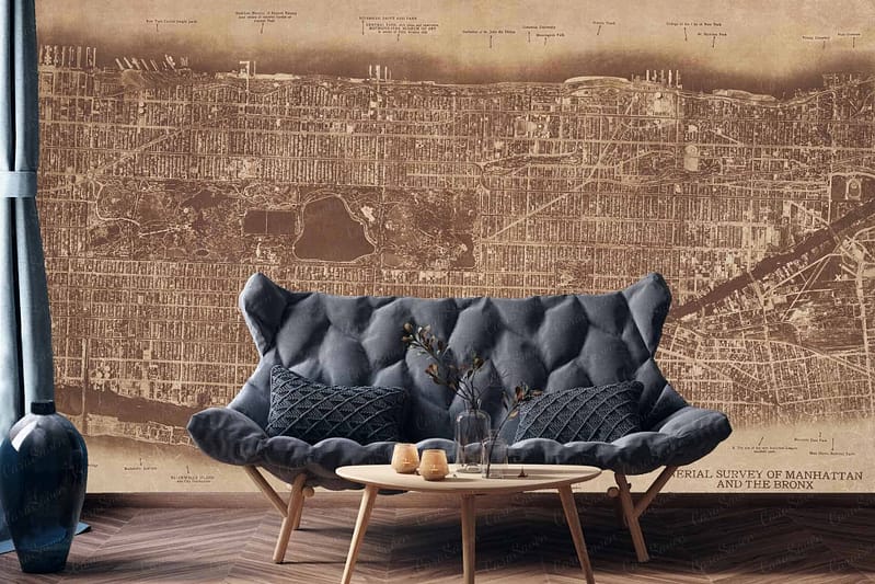 The wallpaper displays a vintage map of NYC, specifically highlighting Manhattan and the Bronx. It features intricate details of streets and landmarks with sepia-toned hues, muted greens, soft blues, and aged parchment colors. A decorative compass rose adds a classic touch in faded gold tones.