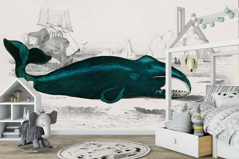 The children's bedroom features a whale-themed mural wallpaper that showcases a large, majestic whale swimming against a serene ocean backdrop. Sailing ships with billowing sails and intricate details float on the water, evoking a timeless maritime adventure. Rich blues and aquamarines dominate the scene, with hints of white from the waves and sails adding contrast. The mural includes delicate accents of gray and earthy browns in the ship's woodwork, harmonizing beautifully with the calming seascape colors.