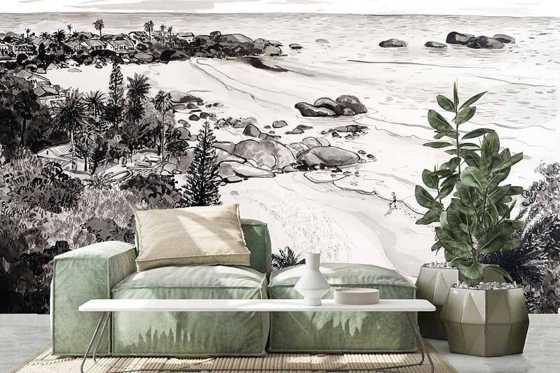 The wall features a black-and-white mural of Cape Town's 3rd Beach at Clifton. It depicts a coastal landscape with beach, rocks, palm trees, and a person walking along the shore. The mural is monochromatic with shades of black, white, and various tones of gray.