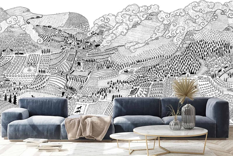 A detailed monochromatic mural of the Cape Winelands' hilly landscape features mountains, forests, fields, and villages. The intricate artwork combines whimsical elements with textured details in shades of black, white, and gray.