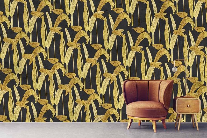 The wallpaper features a dark background adorned with a bold gold leaf pattern, merging rich elegance and vintage allure. The dark hues provide depth, while the shimmering gold leaves add striking contrast and timeless sophistication.