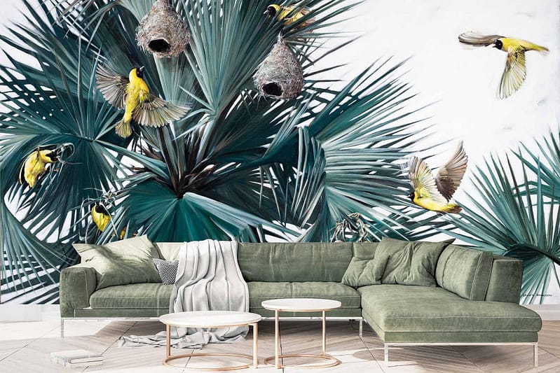 The wallpaper boasts lush green palm leaves intertwined with vibrant hues. Birds in shades of blue, yellow, and red perch gracefully, accompanied by intricate nests. This lively design creates a vivid backdrop where natural elements come to life.