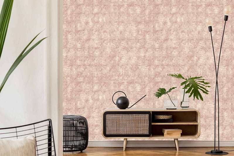 The wallpaper in the modern living room is textured beige, adding depth and warmth to the space. It features subtle variations in tone that create a sophisticated, understated pattern. The neutral beige color serves as a versatile backdrop, complementing other elements like the wooden console table, black watering can, leafy plant, and black floor lamp. This wallpaper provides a chic yet cozy ambiance perfect for contemporary homes.