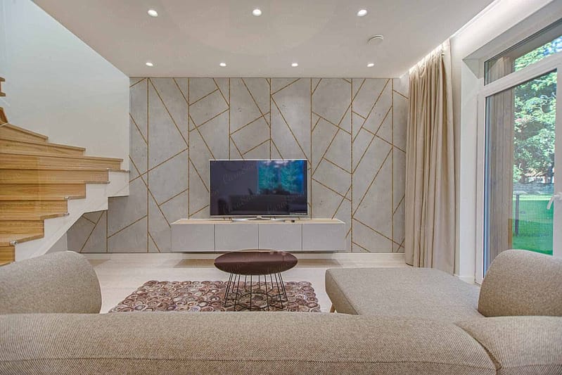 The wallpaper features geometric patterns, with elements in shades of taupe, ivory, and subtle gold accents.