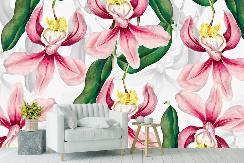 Vibrant pink and yellow orchids with green leaves.